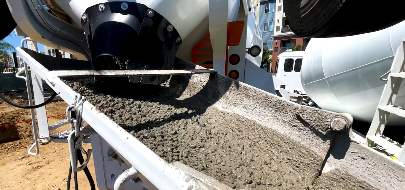 Quality concrete being poured from professional mixer truck
